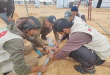 Drilling a Water Well for Displaced People in Gaza GPAA volunteers assembling water pipe fittings at a displaced persons camp in Gaza
