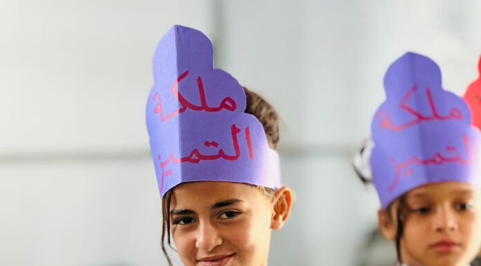 The Gaza Palestinian American Association Supports Al-Furat School and Strengthens Educational Resilience in Gaza A girl wearing a Queen of Excellence crown holding her appreciation certificate from Al-Furat School in Deir al-Balah, Gaza